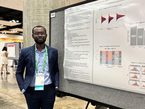 African-American college student standing in front of a research poster