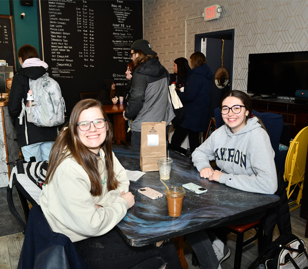 A group of women sitting at a table in a coffee shop