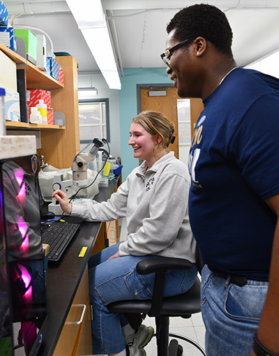  Students Rowland Okafor and Chelsea Kalb in a lab at The University of Akron